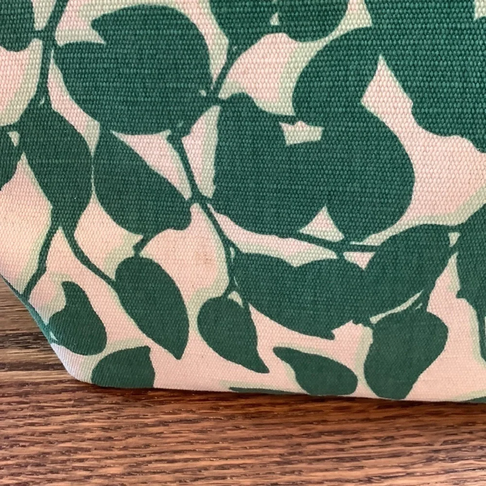 Kate Spade cream colored cloth tote with green leaf pattern.